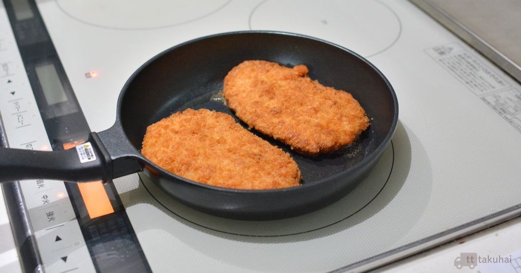 ミールキットのとんかつ2枚をフライパンで加熱しているところ